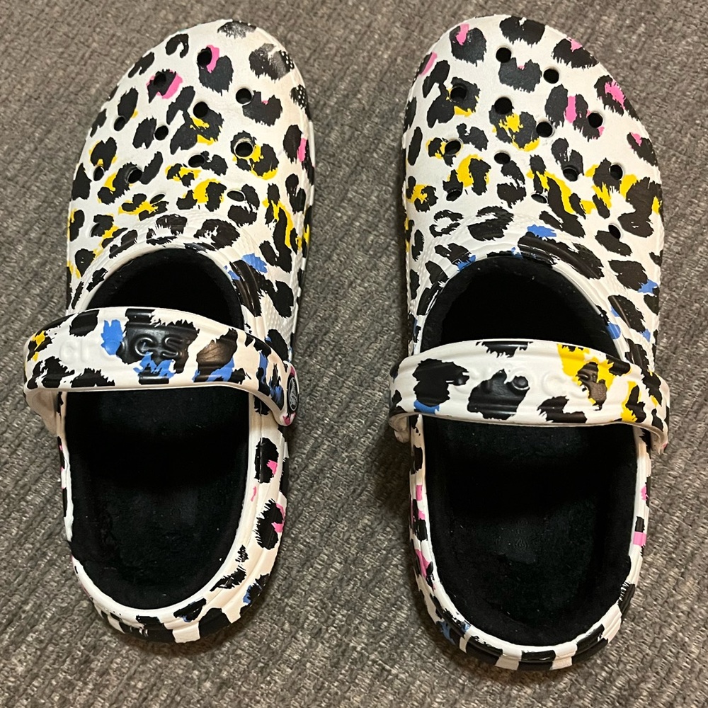 Crocs , cheetah print black pink, blue , yellow, with black fur inside , size 8